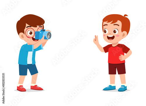 little kid holding camera and take photo of friend