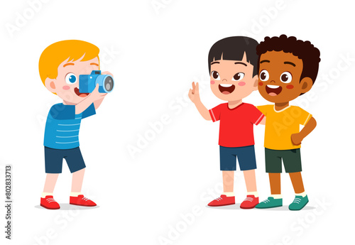 little kid holding camera and take photo of friend