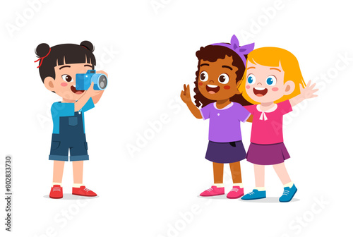 little kid holding camera and take photo of friend