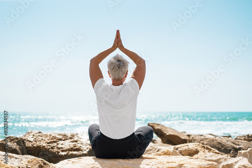 Middle Aged Female Doing Yoga Exercises. Mindfulness Zen Spiritual Meditation Tips. Kundalini Yoga. Reiki Meditation. Relaxing. Unity With Nature. Sea or Ocean Coast Beach