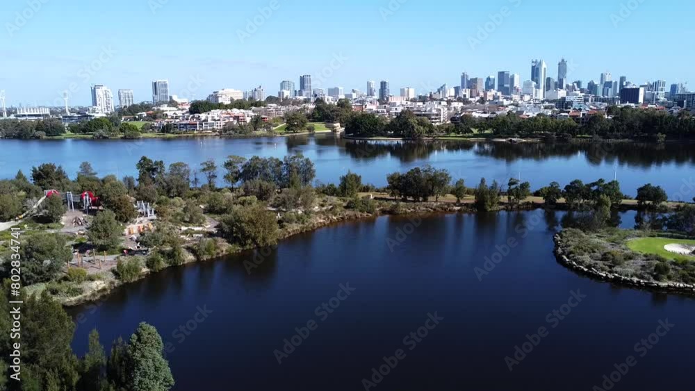 Still aerial view of Perth city skyline and the Swan River in Western Australia. Blue water expanses and parkland. Still aerial view of Perth city skyline and the Swan River in Western Australia. Blue water expanses and parkland.