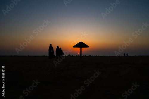 Silhouette of people walking on the beach in the evening at Al Seif Beach in Jeddah, Saudi Arabia  photo