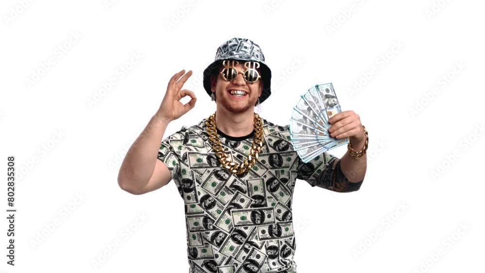 Successful rich man holding bundle of dollars and showing ok symbol by fingers, portrait in studio Successful rich man holding bundle of dollars and showing ok symbol by fingers, portrait in studio