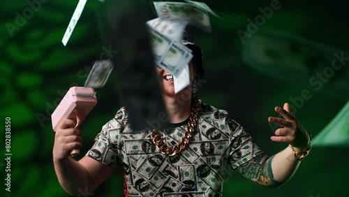 Art shot with crazy guy shooting from pistol by money, medium portrait in studio, rich and success