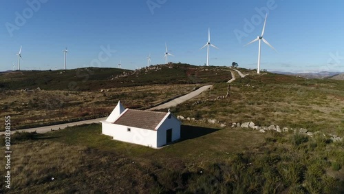 Church in Mountains with Wind Turbines Aerial View photo