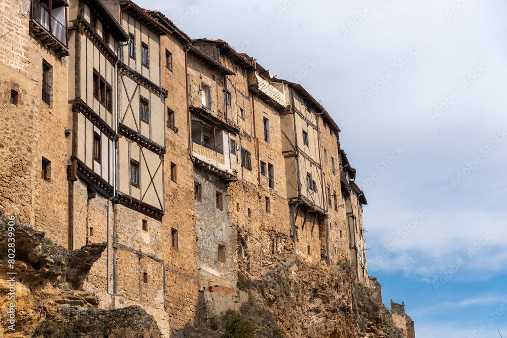 View of the façade of some brick and wooden houses in the tourist town of Frías in Burgos.