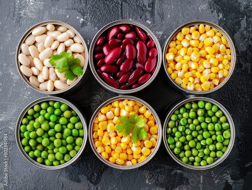 Opened tins of canned corn, green peas, red and white beans. Aesthetic macro photo, texture background