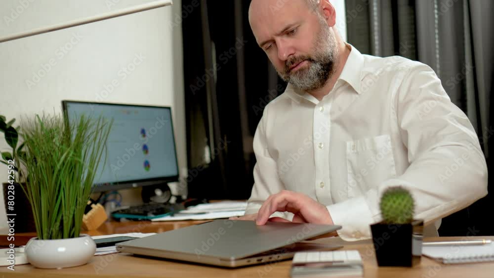 Man opens notebook and started typing on keyboard, nervous person at office desk, solving business problems. Modern technology, internet and people concept Man opens notebook and started typing on keyboard, nervous person at office desk, solving business problems. Modern technology, internet and people concept