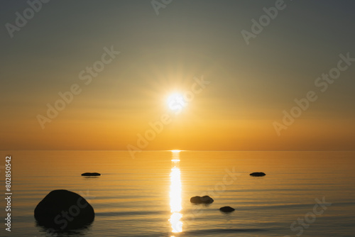 Bright sunset on the shore of the Baltic Sea in Estonia in spring evening. © Dmitri