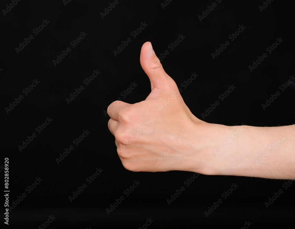 Human hand shows a thumb up gesture Human hand shows a thumb up gesture