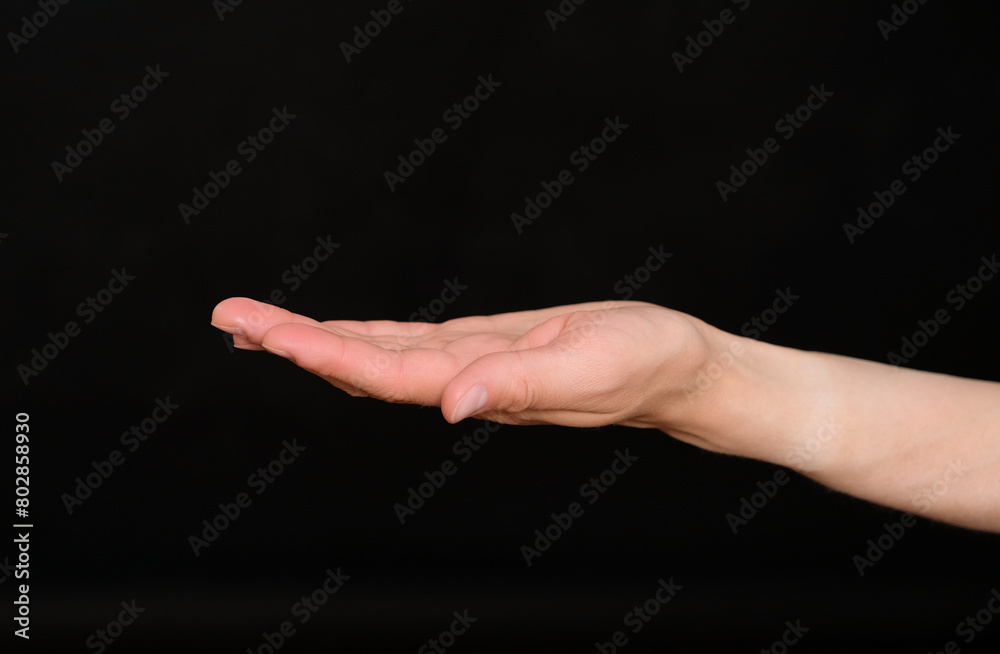 The woman holds out an empty palm