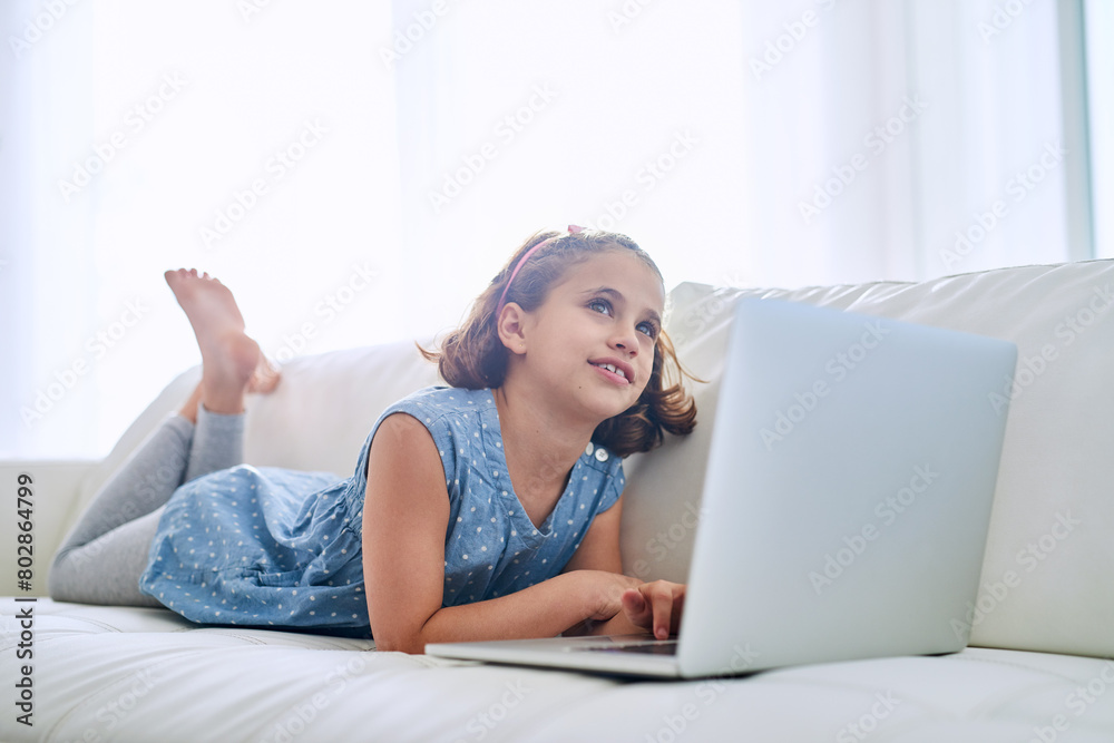 Thinking, laptop and girl child in home on sofa for game, show or streaming movie online in lounge. Kid, idea and computer in living room for learning, education or watch cartoon to relax in house Thinking, laptop and girl child in home on sofa for game, show or streaming movie online in lounge. Kid, idea and computer in living room for learning, education or watch cartoon to relax in house