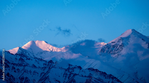 Pink colors at sunrise over snow-capped Himalayan mountains near Leh in India's Ladakh region
