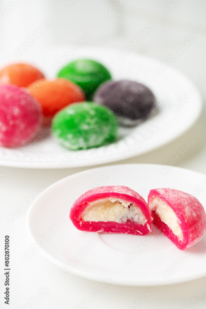 Multi-colored Japanese cakes Mochi in a white plate Multi-colored Japanese cakes Mochi in a white plate
