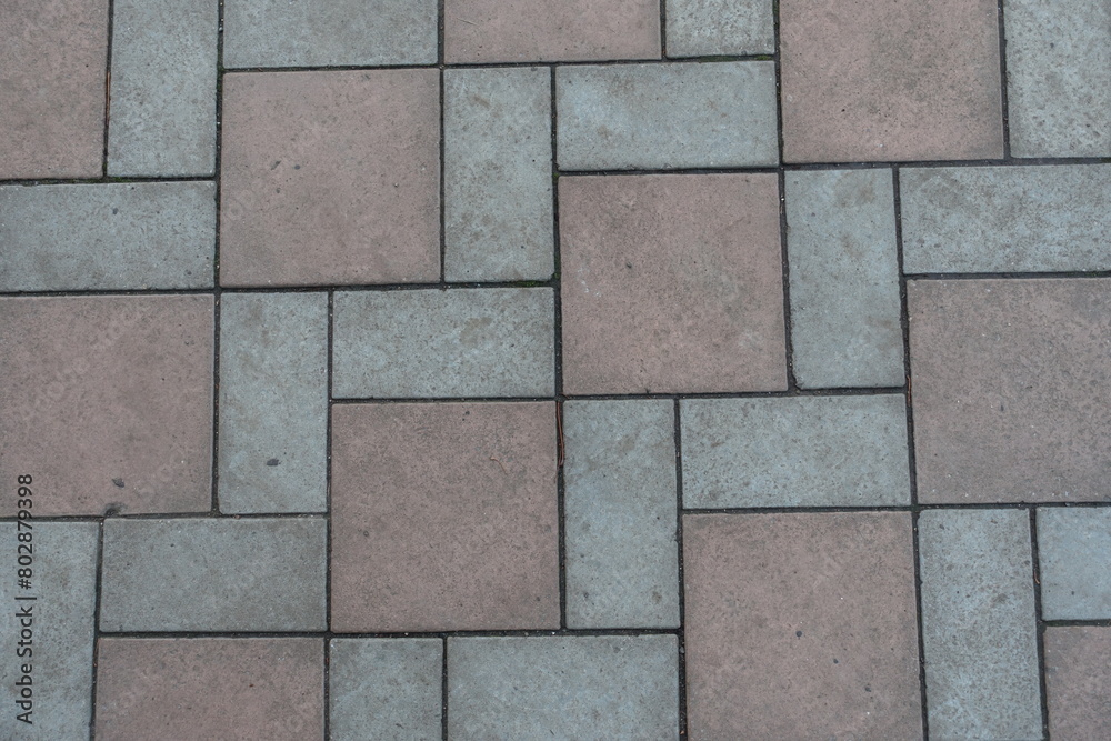 Fototapeta premium Background - geometric pavement made of grey and brown concrete tiles