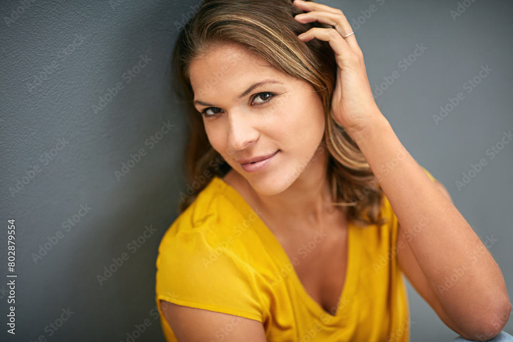 Young woman, beauty and hand in portrait with smile for confidence and pride in hair treatment isolated in studio. Female person or model and haircare for glow with keratin formula on gray background Young woman, beauty and hand in portrait with smile for confidence and pride in hair treatment isolated in studio. Female person or model and haircare for glow with keratin formula on gray background