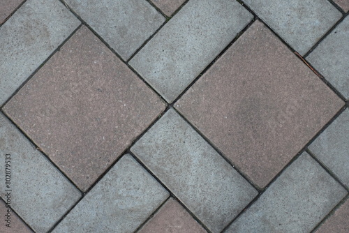 Close shot of geometric pavement made of grey and brown concrete tiles