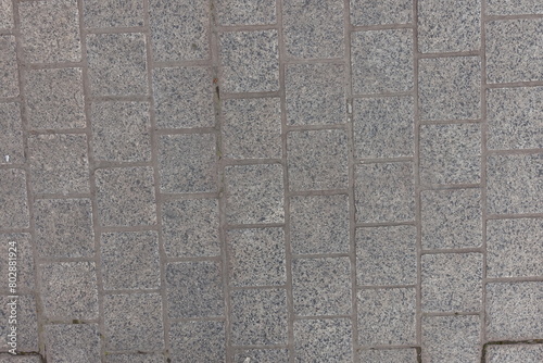 Surface of pavement made of gray unpolished granite stone blacks photo