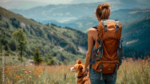girl with a backpack and a dog standing on a hill