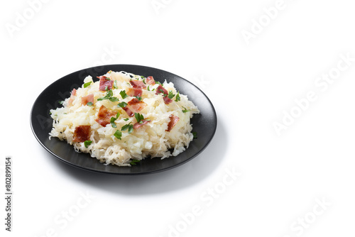 Slovak potato dumplings halusky with steamed sauerkraut and bacon isolated on white background. Copy space