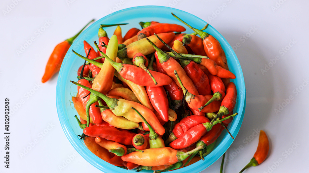 red cayenne pepper in a green bowl. spicy flavored vegetables