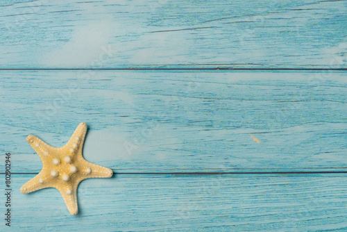 Starfish on a blue wooden background. Top view, copy space