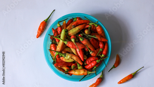 red cayenne pepper in a green bowl. spicy flavored vegetables