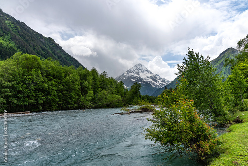 Beautiful landscape of a river with mountains in the background. Psysh River in the Caucasus Mountains.