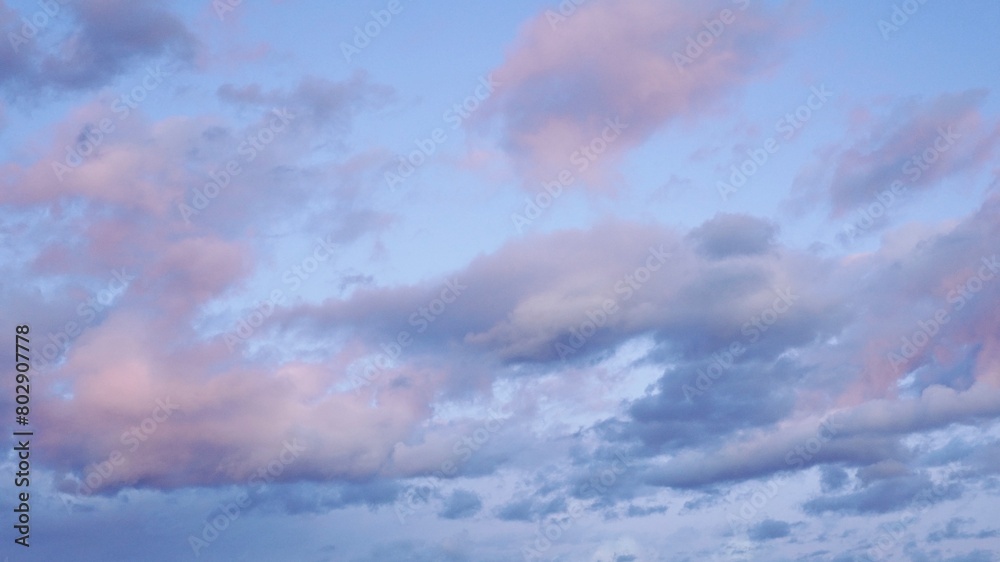 Lilac sunset clouds in clean blue sky. Lilac sunset clouds in clean blue sky.