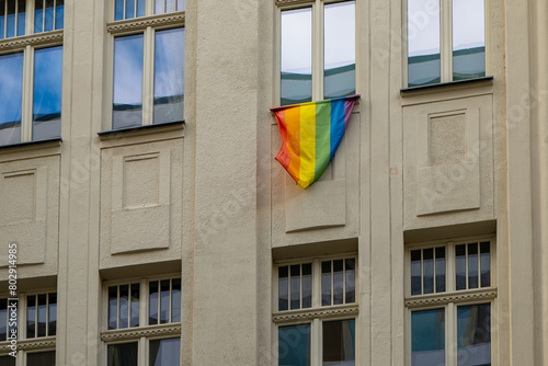 Photography rainbow flag hanging from a window as a sign of tolerance