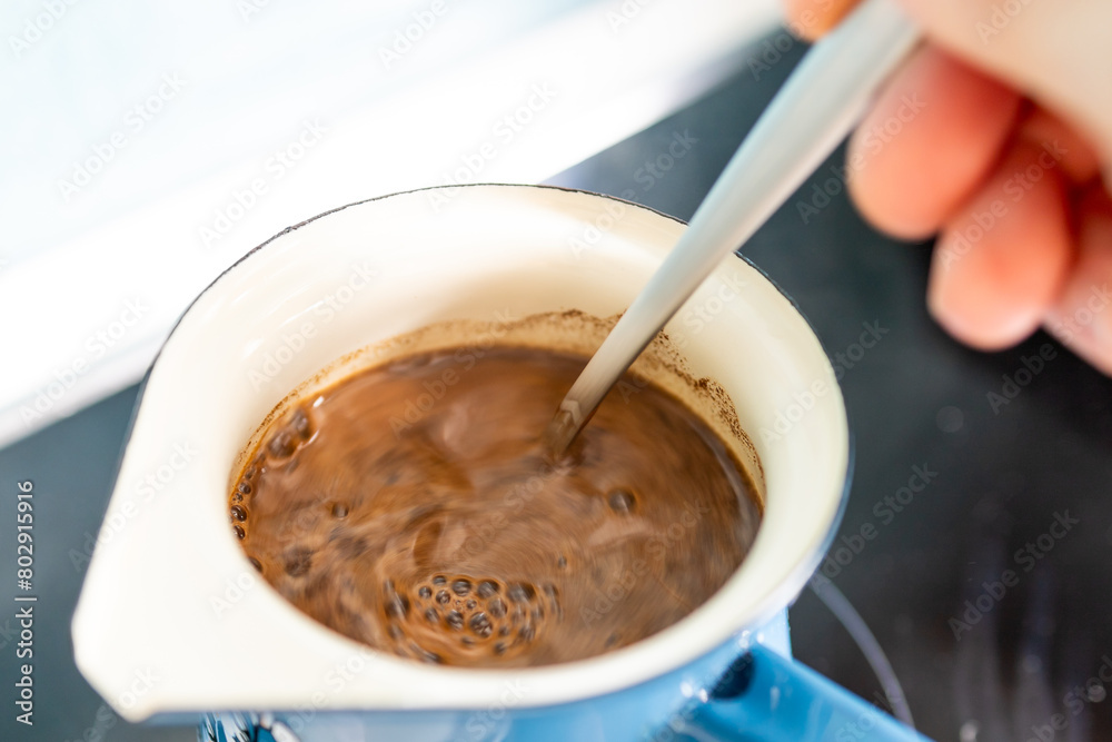 Add aromatic ground coffee to the coffee pot with a spoon and prepare excellent coffee.