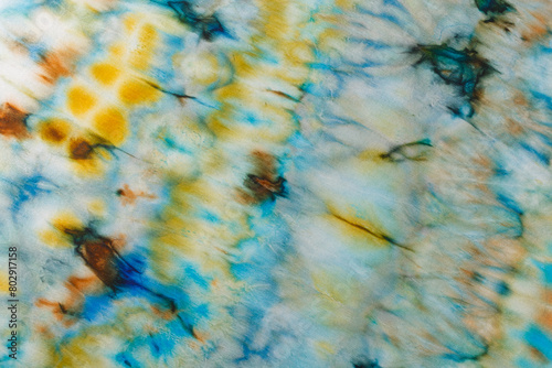 abstract pattern on silk fabric texture in blue, yellow, green colors