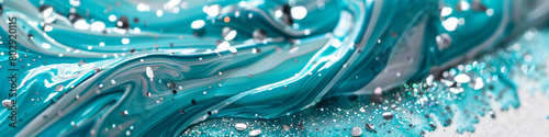A tranquil turquoise marble ink glides across a captivating abstract background, shimmering with silver and aquamarine glitters."