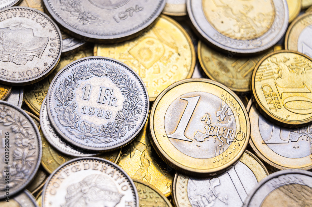Euro and Swiss Franc coins next to each other, 1 euro and 1 CHF coins
