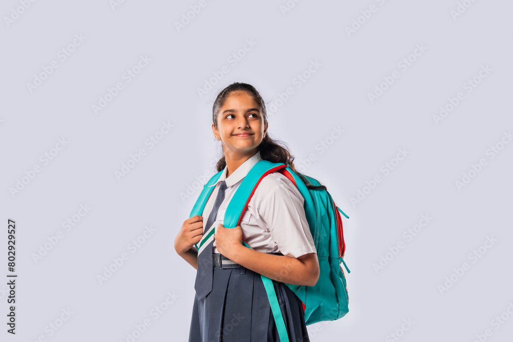 Portrait of cheerful Indian asian teenage schoolgirl with school uniform and backpack Portrait of cheerful Indian asian teenage schoolgirl with school uniform and backpack