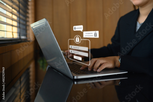 Businesswoman typing the password on laptop to access account on website. Cybersecurity concept