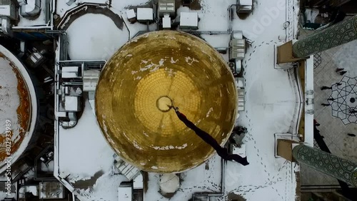 Beautiful snowy day in Qom, Iran. Holy shrine of lady Fatima Masoumeh. Aerial video footage recorded by a drone with high quality rendering in full HD and 4K resolution in nature. photo