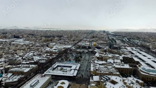 Beautiful snowy day in Qom, Iran. Holy shrine of lady Fatima Masoumeh. Aerial video footage recorded by a drone with high quality rendering in full HD and 4K resolution in nature. photo