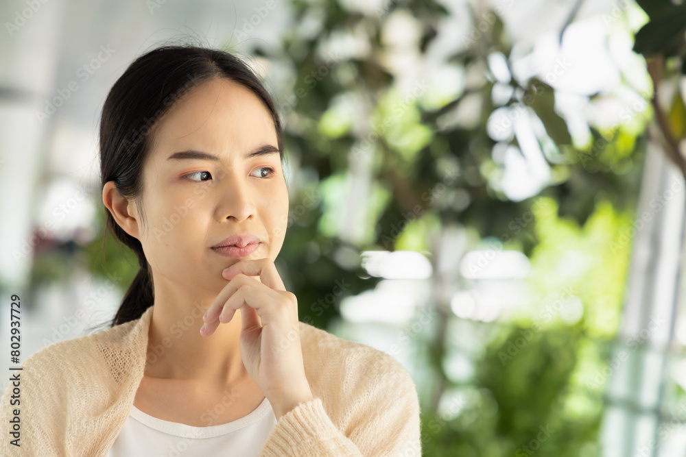 Serious and pensive asian woman thinking, finding good idea or plan with stressful mood Serious and pensive asian woman thinking, finding good idea or plan with stressful mood