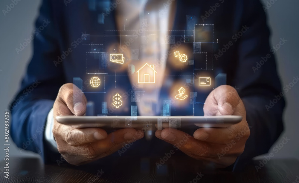 A businessman holding tablet with glowing real estate icons A businessman holding tablet with glowing real estate icons