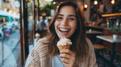 Cheerful young woman enjoying a vanilla ice cream cone in a cafe