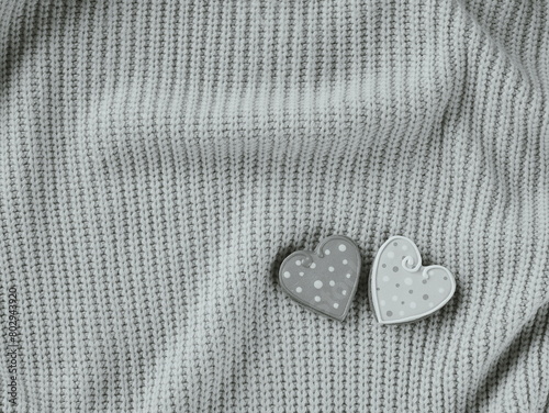 Cozy Comfort with a Touch of Love. Two Polka Dot Heart Buttons on a Knitted Grey Sweater photo