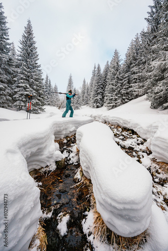 Mountaineer backcountry ski walking ski alpinist in the mountains. Ski touring in alpine landscape with snowy trees. Adventure winter sport. Low Tatras, slovakia photo