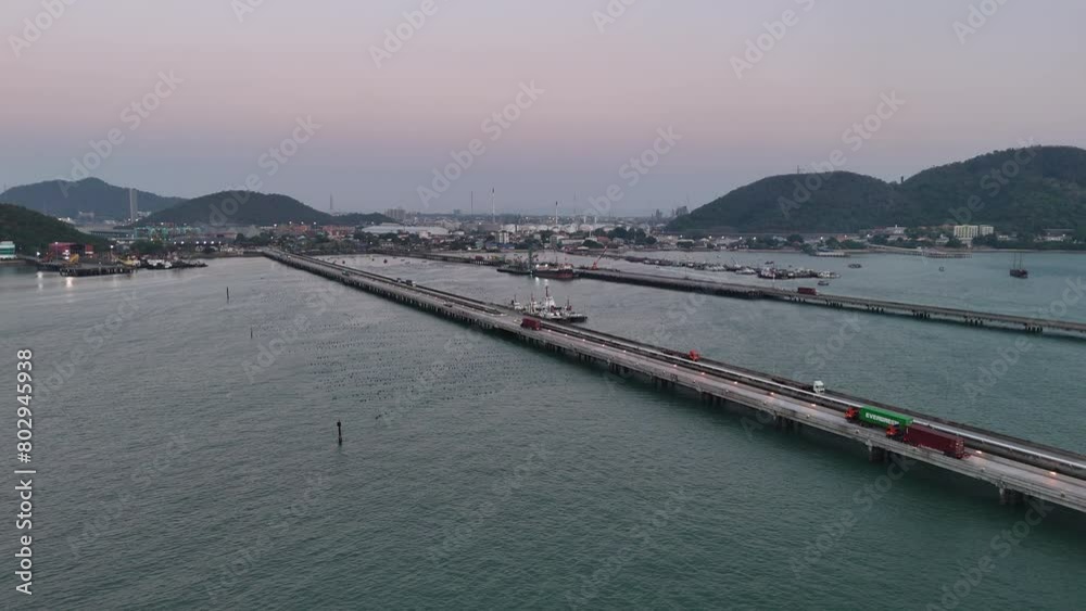 Container Truck running on bridge cargo internation sea port. container truck on bridge at sunset Container Truck running on bridge cargo internation sea port. container truck on bridge at sunset