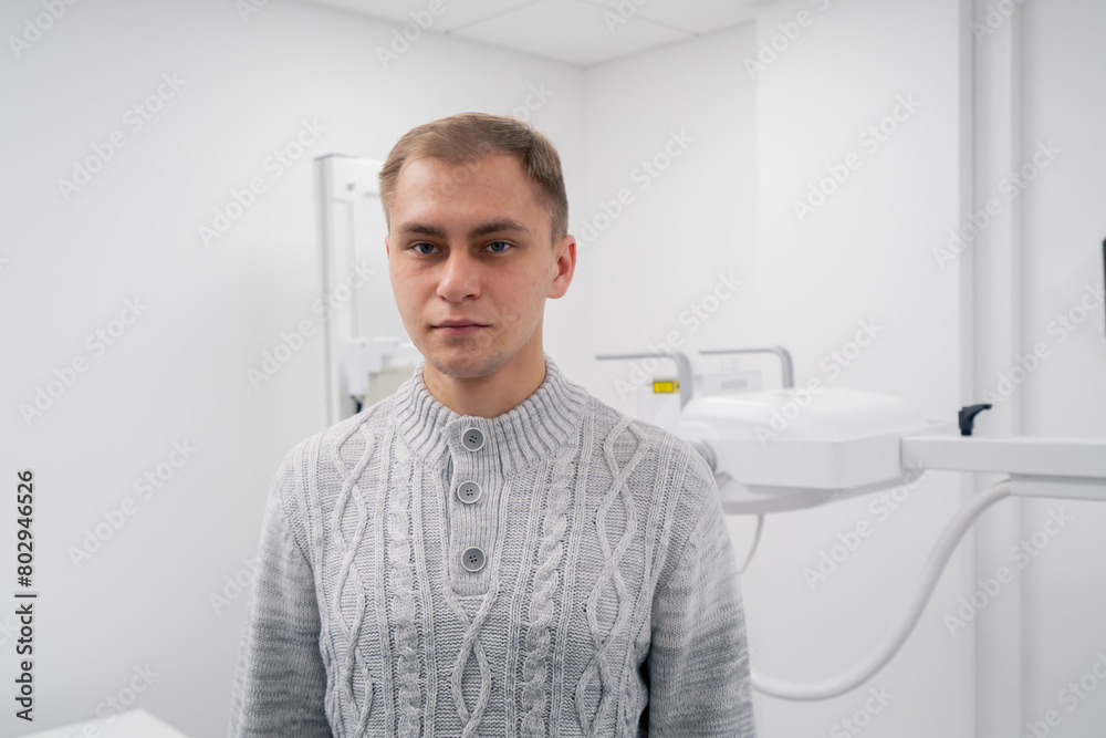 Fototapeta premium in a private clinic in a white x-ray room a patient prepares for a procedure