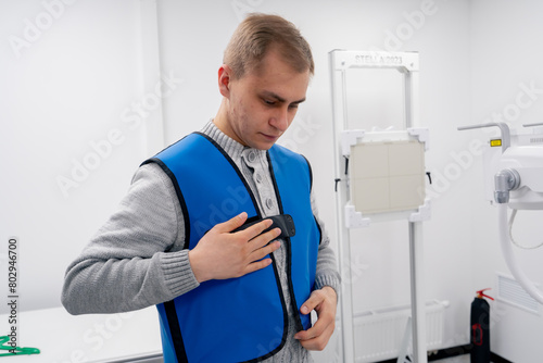 in a private clinic in a white x-ray room a patient prepares for a procedure