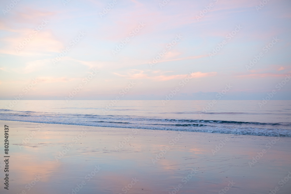 reverse sunset, Woodgate beach Queensland Australia, pastel pink clouds reflections sand, calm waves ripples ocean sea, coastal lifestyle, holiday vacation travel