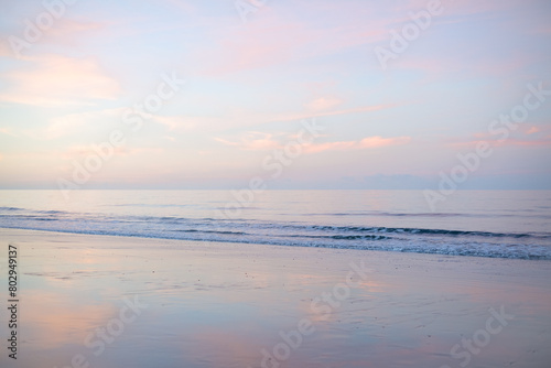 reverse sunset  Woodgate beach Queensland Australia  pastel pink clouds reflections sand  calm waves ripples ocean sea  coastal lifestyle  holiday vacation travel
