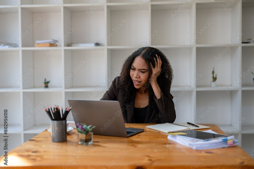 businesswoman sitting at work stressed , out working hard Feeling stressed out and dizzy from your job businesswoman sitting at work stressed , out working hard Feeling stressed out and dizzy from your job