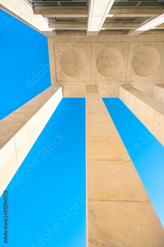Beautiful geometric abstraction of parts of architectural elements against a blue sky. Vertical photo